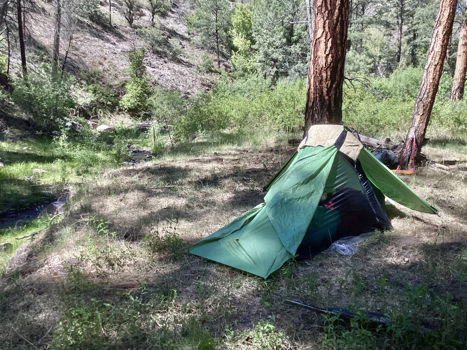 a very small tent beside the creek