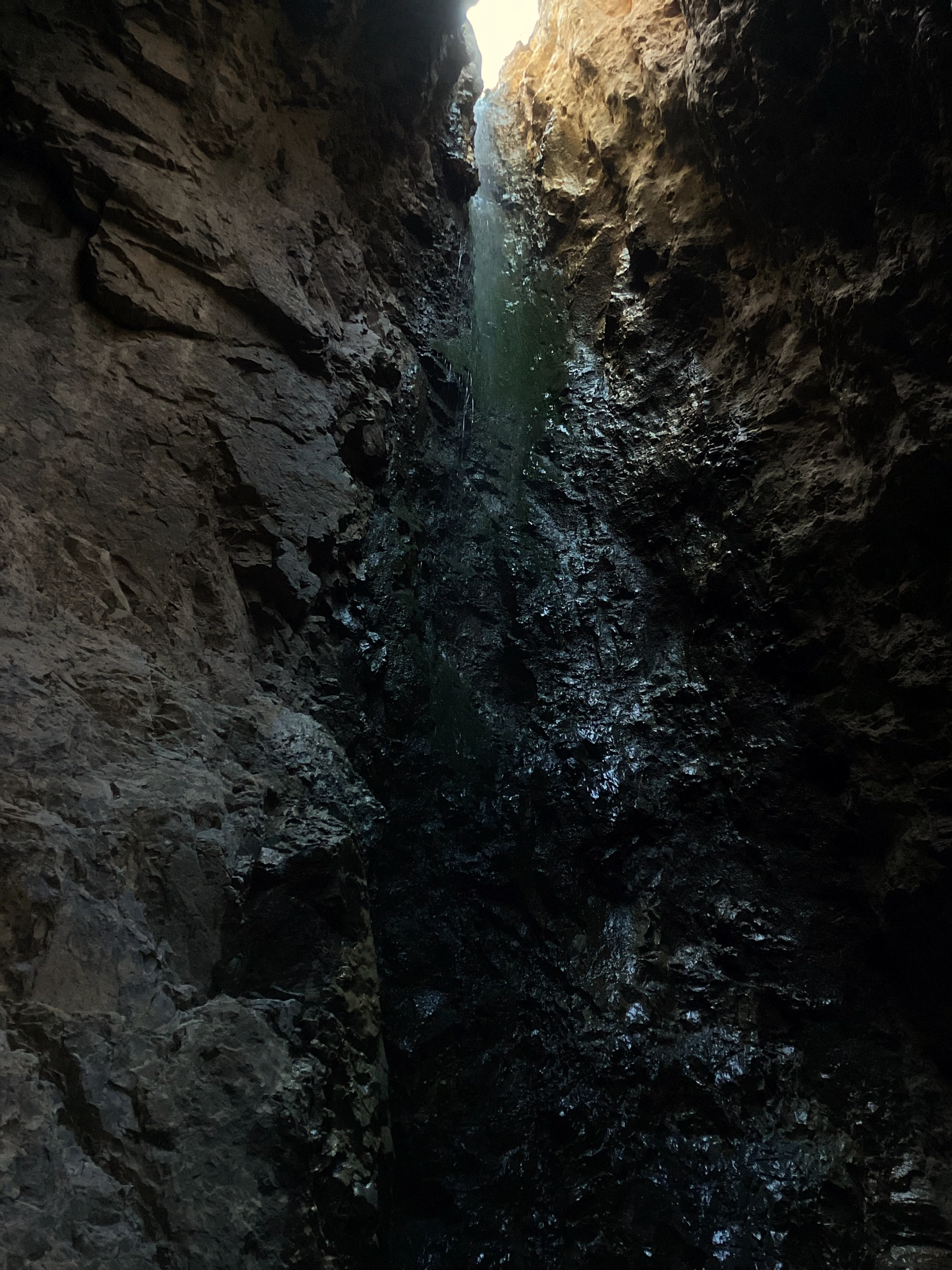 tall waterfall in a dark grotto