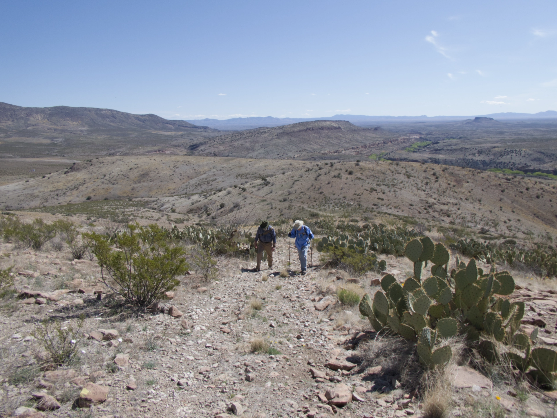 two men climbs a steep hill