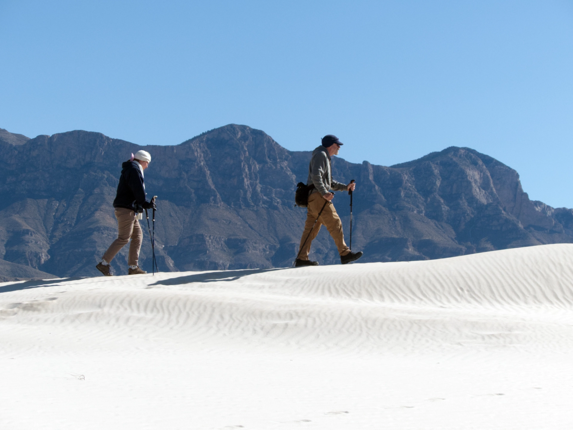Ken and Helena hiking in the dunes zoom