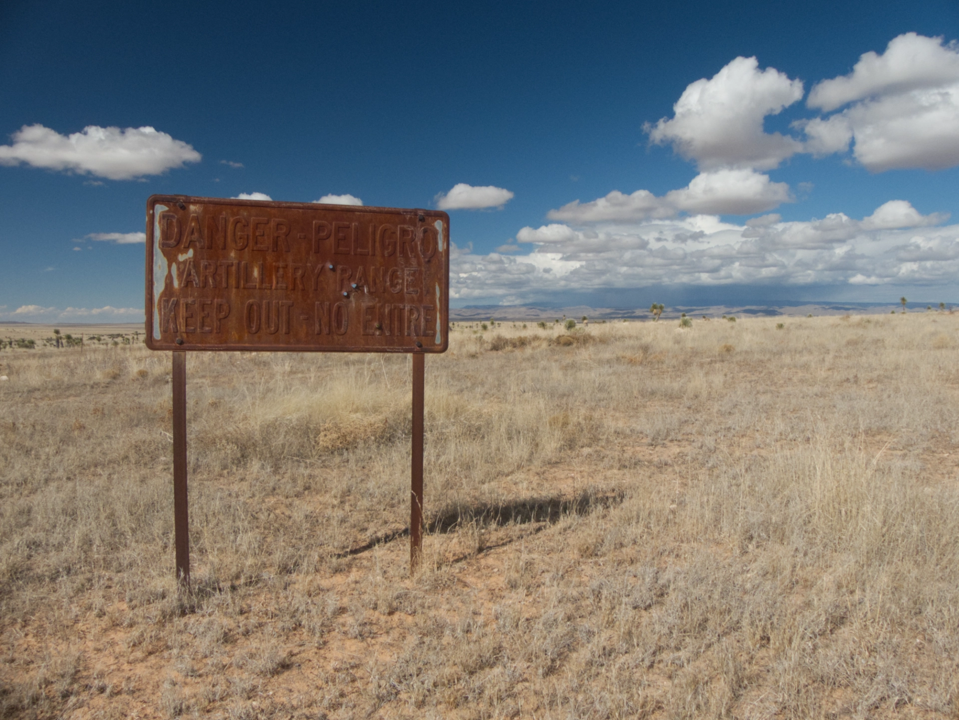 bullet-riddled rusty sign entering Fort Bliss